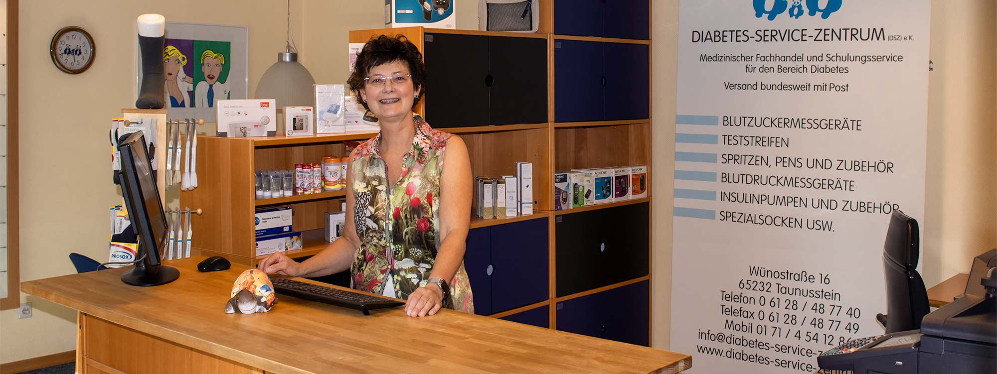 Frau Stoll steht im Erdgeschoss hinter der Verkaufstheke.